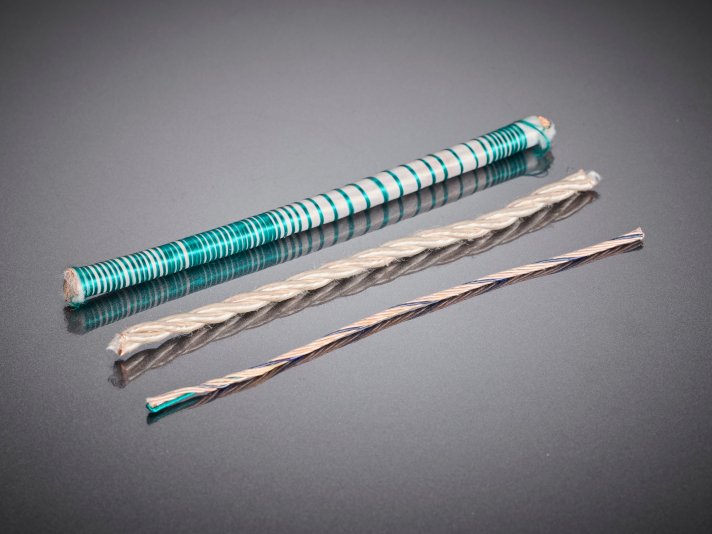 Bifilar windings of HF litz wires in various designs, used in industrial electronic assemblies to specifically influence electrical properties such as coupling and symmetry.