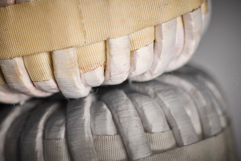This detailed image illustrates the precise winding structure of the HF litz wire, specifically designed for use in on-board chargers with wide-bandgap semiconductors to reduce AC losses at high switching frequencies.