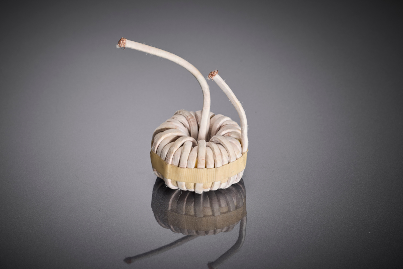 The toroidal core choke shows the implementation of the optimized litz wire solution in the real OBC component and illustrates the contribution of the winding to increased efficiency and thermal stability of modern AC/DC on-board chargers.